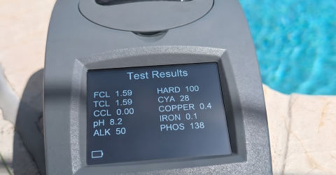 SpinTouch water test results on the pool deck during a weekly maintenance visit